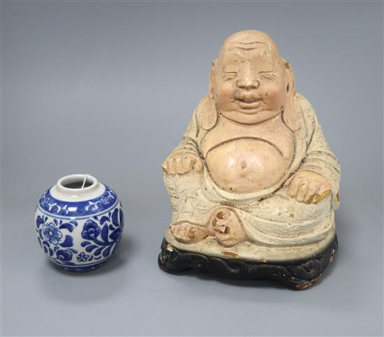 A Chinese Buddha and a blue and white vase